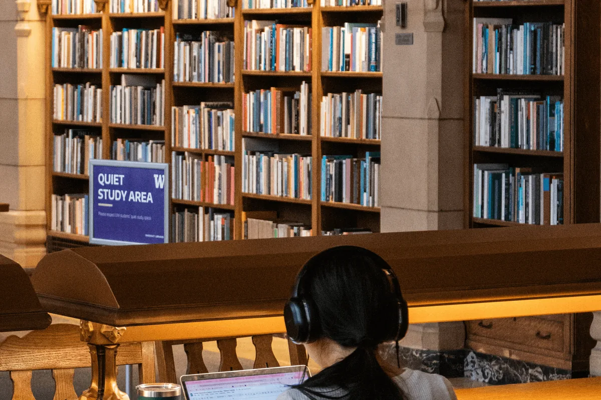 A student reading in a university library