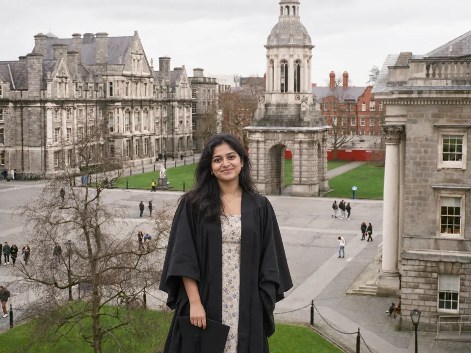 Indian graduate in front of Trinity College Dublin
